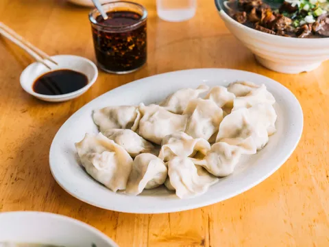 Steamed dumplings with dipping sauce at Yuanbao Jiaozi
